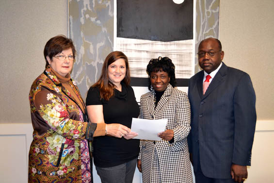 From left, Dr. Myrtis Tabb, associate vice president for finance and administration at Delta State, and Laura Howell, arts education coordinator for the Bologna Performing Arts Center, present Dr. Sherry Shepard, curriculum director for the West Bolivar School District, and Henry Phillips, superintendent of the West Bolivar School District with a letter congratulating the BPAC in partnership with the West Bolivar School District for being selected as one of 12 teams nationwide to attend the Kennedy Center Partners in Education Institute at the Kennedy Center April 25-28, 2012.
